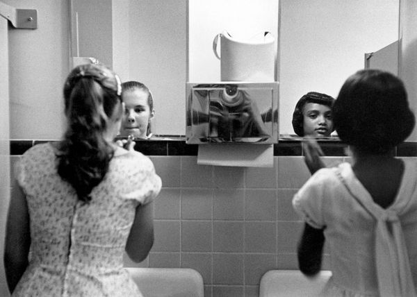 Eve Arnold, A Black Girl and a Whit Girl Make Up in the Ladies Room Before an Integration Dinner Party During the Civil Rights Strikes in America, 1958