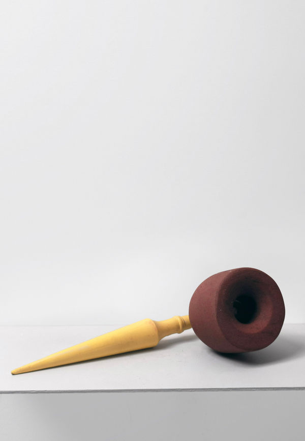 Contemporary minimalist sculpture made of stone and metal that resembles an ambiguous artifact