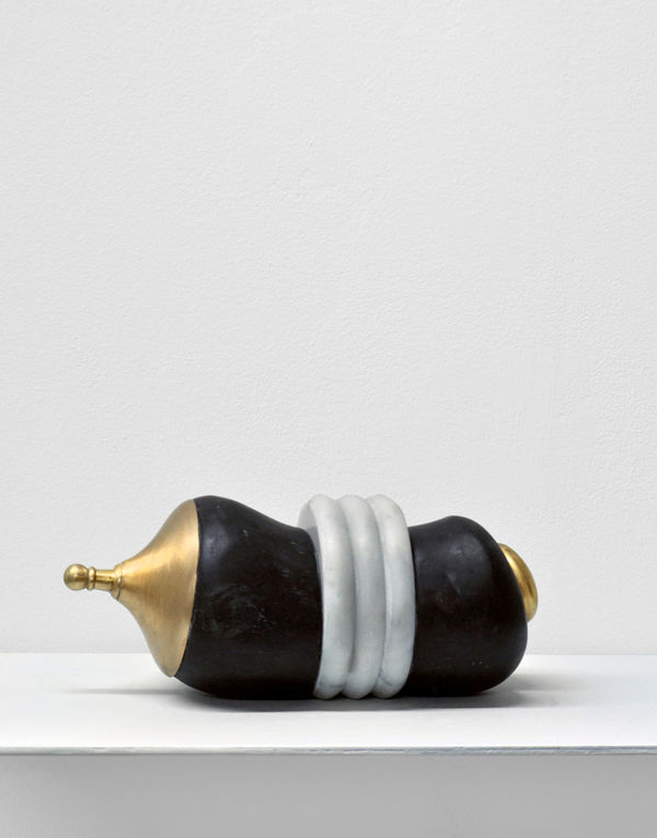 Contemporary minimalist sculpture made of stone and metal that resembles an ambiguous artifact