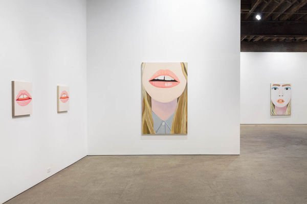 Installation view of Brian Calvin's fourth show at Anton Kern Gallery, featuring a group of paintings of faces, lips, mouths, poses, and a mirror.
