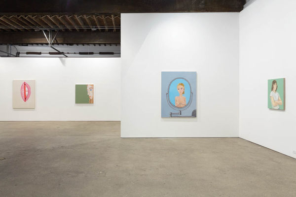 Installation view of Brian Calvin's fourth show at Anton Kern Gallery, featuring a group of paintings of faces, lips, mouths, poses, and a mirror. Multiple works featured, notably a girl a mirror.