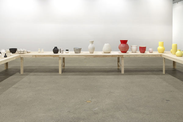 Installation view of Shio Kusaka's second show at Anton Kern Gallery, featuring a large collection of unique porcelain pots. Red and black pots.