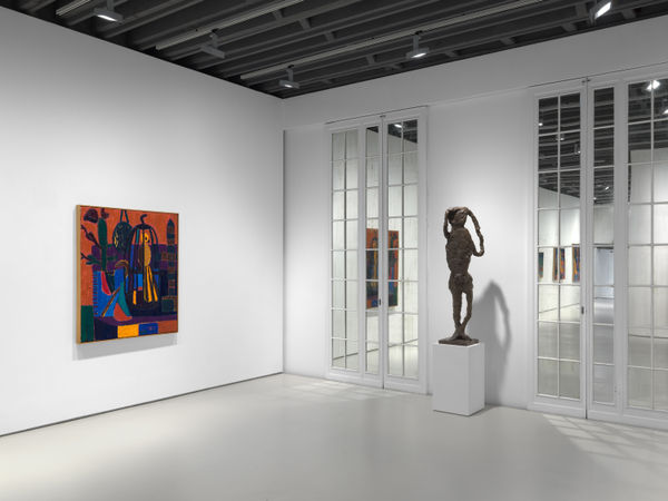Installation view of Tal R's first exhibition with the gallery featuring paintings and sculptures. This shot features a painting harmoniously alongside a sculpture.