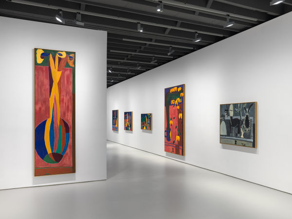 Installation view of Tal R's first exhibition with the gallery featuring paintings and sculptures. Large photo featuring many of the painted works in the show.
