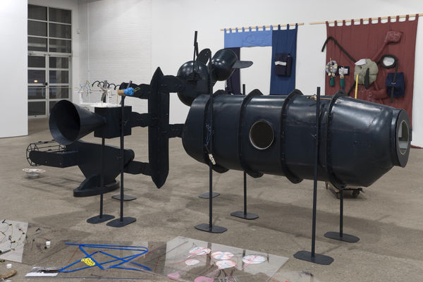 Installation view of John Bock's fifth show at Anton Kern Gallery. Buchse sculpture, featuring a metal body with other objects and a video installation.