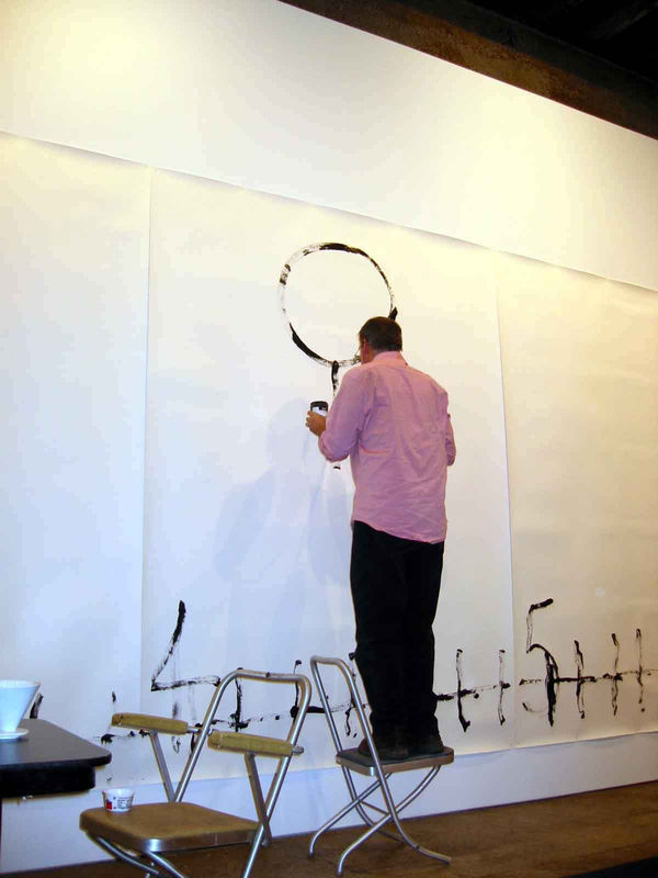 Installation view of Matt Mullican's One Night Performance featuring the artist "under-hypnosis." Mullican draws while under hypnosis.