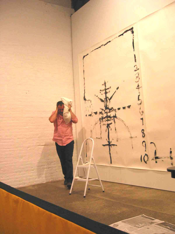 Installation view of Matt Mullican's One Night Performance featuring the artist "under-hypnosis." Mullican becomes agitated, stepping away from drawing.