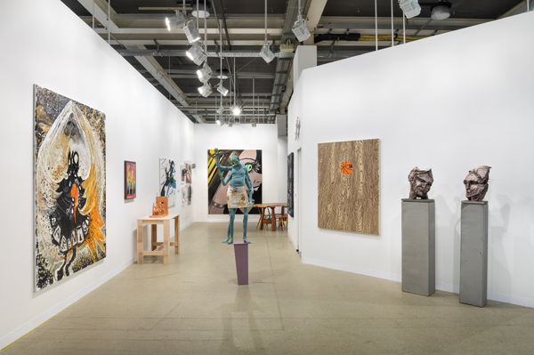 Installation view of Art Basel featuring the majority of works in the both, including sculptures, paintings, and more.