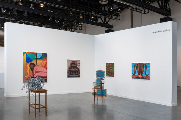 Installation view of dual booth featuring Julie Curtiss and Marepe. Julie's work is primarily paintings and Marepe's are the sculptures in the center.