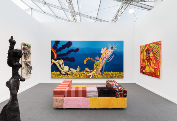 Interior view of the booth featuring a large Pessoli painting.