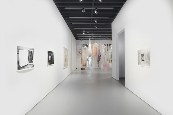 Installation view of the 2022 exhibition "Photographic Pictures" with hallway perspective view of white floors, walls, artworks and cieling