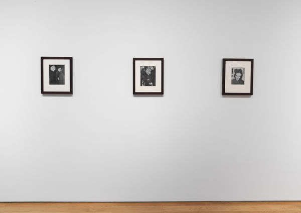 Installation view of vintage Weegee photos, three works shown.