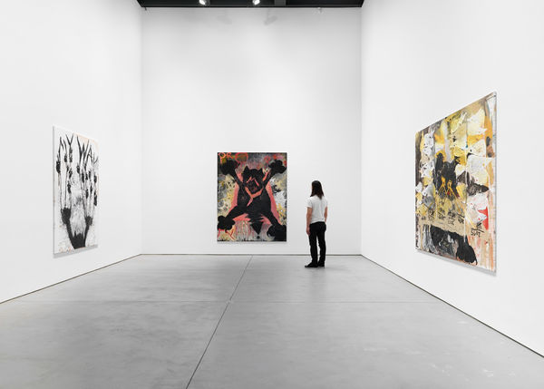 Installation view of Sankt Rufus, a solo exhibition featuring the works of Bendix Harms. Onlooker stares at My Property, an oil work by Harms. Two other works presented.