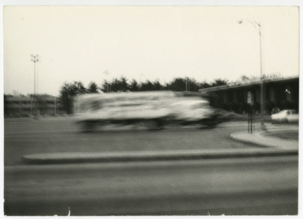 Black and white blurry image of a school bus