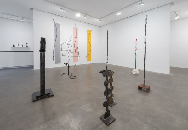 Installation View of Susan Inglett Gallery with many large vertical sculptures by Alain Kirili