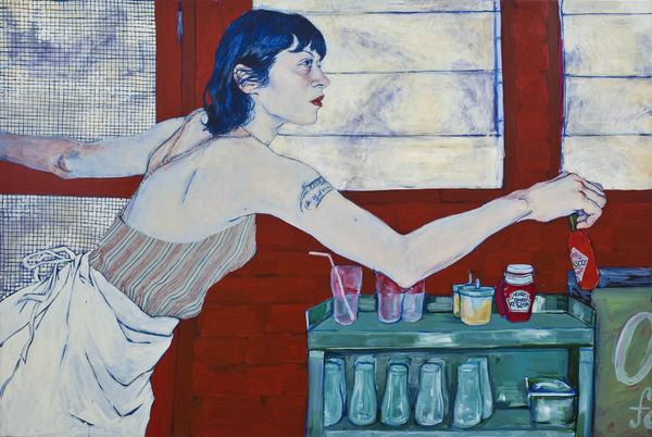 Woman wearing an apron reaches across a cart with bottles on it