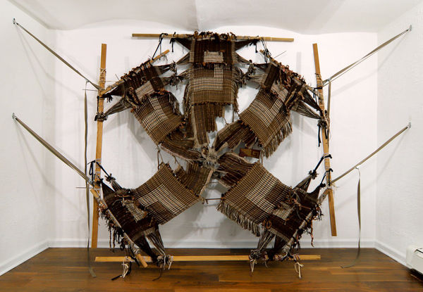 Kira Dominguez Hultgrens “Colita de Rana or Zip Ties” (2022), in which five separate burlap-colored panels meet in a loose knot at the center.Credit...Kira Dominguez Hultgren and Heroes Gallery