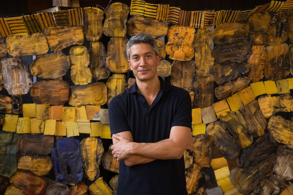 Marwan Zakhem in front of Serge Attukwei Clottey's work