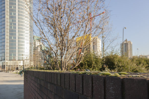 Slinkachu Gods green earth context shot (on a fence)
