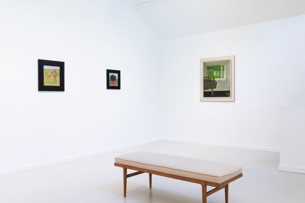 Two Albert York paintings in thick black frames on an adjacent wall to a dense green Fairfield Porter interior painting of a laundry room.