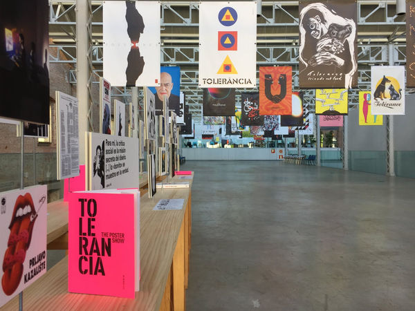 Exhibition installation of posters, including the artist's work "Friends Not Food," at the Tolerance Poster Show in Madrid