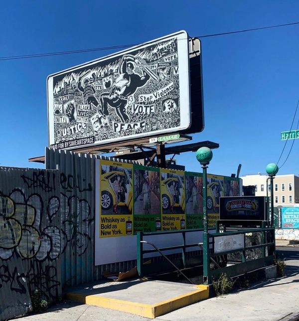 Photograph of Sue Coe's billboard-sized artwork "We Are Many, They Are Few"