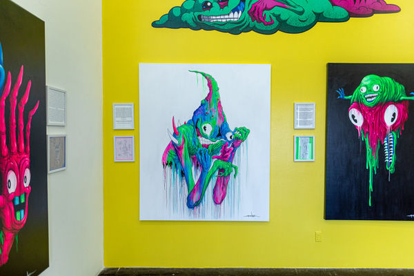install photo of brightly colored artworks by Alex Pardee