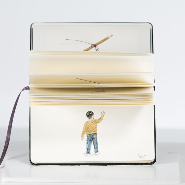 drawing in a moleskin notebook of a young boy with his back turned to the viewer and one arm lifted towards the sky