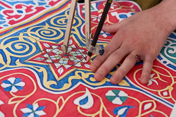 Yasmin Hayat in her studio working on the analysis of Lulu Lytle’s antique Egyptian tent panel. The analysis and breakdown of the geometric design in the tent panel informed the development of Yasmin’s Rumi pattern. The Rumi fabric is now available for purchase at Soane Britain. Image courtsey of Soane Britain.