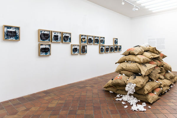 View of the installation Le chemin de fer by Jean David Nkot featuring the figure of Harriet Tubman printed on jute bags