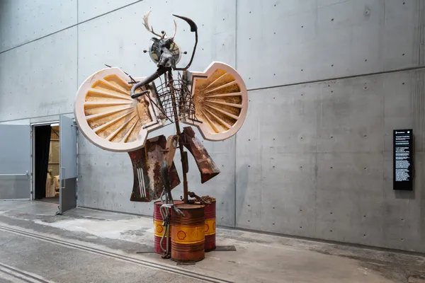 Tennant Creek Brio, UAP: Unidentified (Ab)original Phenomenon (2024), steel, oil barrels, mining ball bearings, found petrochemical signage, car bonnets, deer antlers, found objects and junk assemblage, video and sound, 450 x 320 x 110 cm / 177 1/8 x 126 x 43 1/4 in