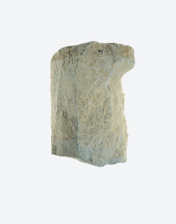 Focusing on the "primordial" fountainhead through a chalky, white stone fragment captured on color negative.