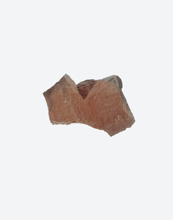 A deeply weathered, heart-shaped stone, displayed as an archaeological find on white.