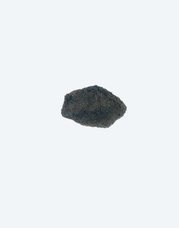 A grey and black speckled stone fragment with a crystalline texture, on a white background.