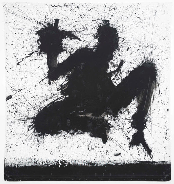 Silhouette of a crouching figure in black paint splatters by Richard Hambleton