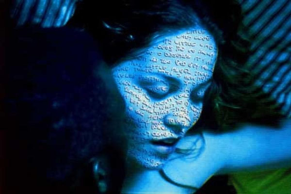 Photograph of blue woman with writing on her face