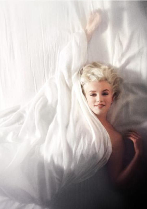 Carbon print of Marilyn Monroe from a high vantage point, wrapped in bedsheets on a bed