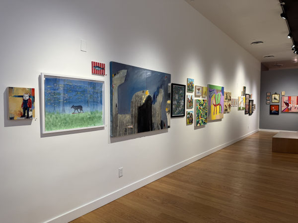 a wall with paintings of animals, real and imagined