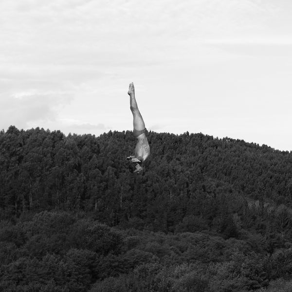 Movement study - Diving 7. Diver Alessandro de Rose (Ita) of the Red Bull World Series Cliff Divers. Over forests near Bilbao, Spain. Prints of athletes. By movement photographer Simon Tomkinson.