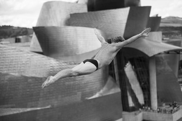 Movement study - Diving 1. Diver Andy Jones (USA) of the Red Bull World Series Cliff Divers. At La Salve Bridge, Bilbao, Spain. Prints of athletes. By movement photographer Simon Tomkinson.