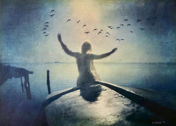 girl in boat with arms out and flock of birds.