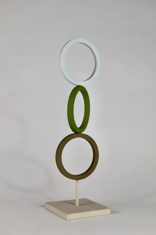 Sculpture with three vertical coloured steel rings