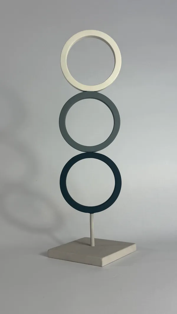 Sculpture with three vertical coloured steel rings