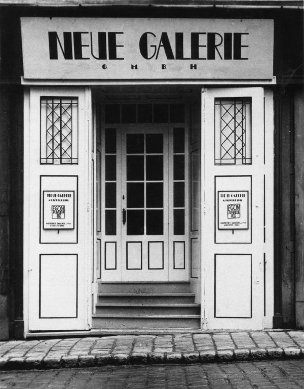 Black and white photograph of the entrance door and signage for the Neue Galerie art gallery in Vienna, Austria, dating to circa 1925