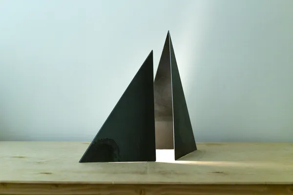 GIZA A folded mill-scale steel silhouette concealing a luminous interior. An exploration of shadow and light, dimmable to touch. Edition of 12.