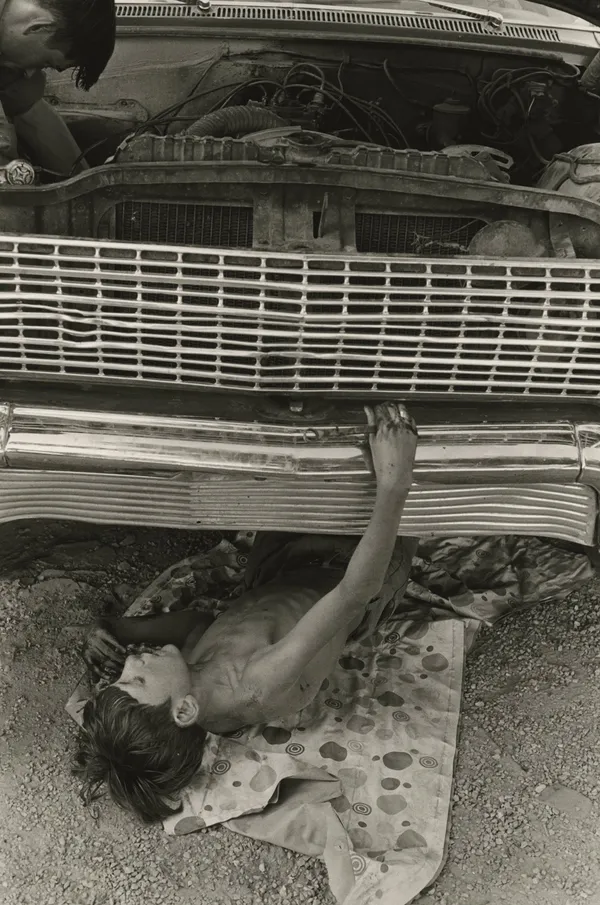 William Gedney, Bill Cornett, Jr. under car, Kentucky, 1972