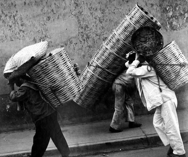 Leon Levinstein, Untitled (men hauling carrying baskets on head on backs), n.d.
