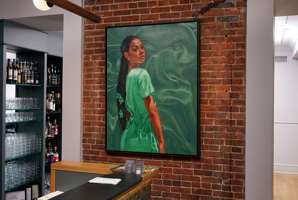 Monica Ikegwu, Olivia, Oil on canvas, 2020, welcomes Cree guests at the Host Desk.