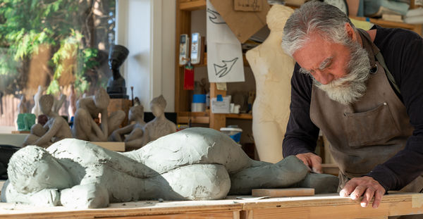 Artist at work in ceramic sculpture studio