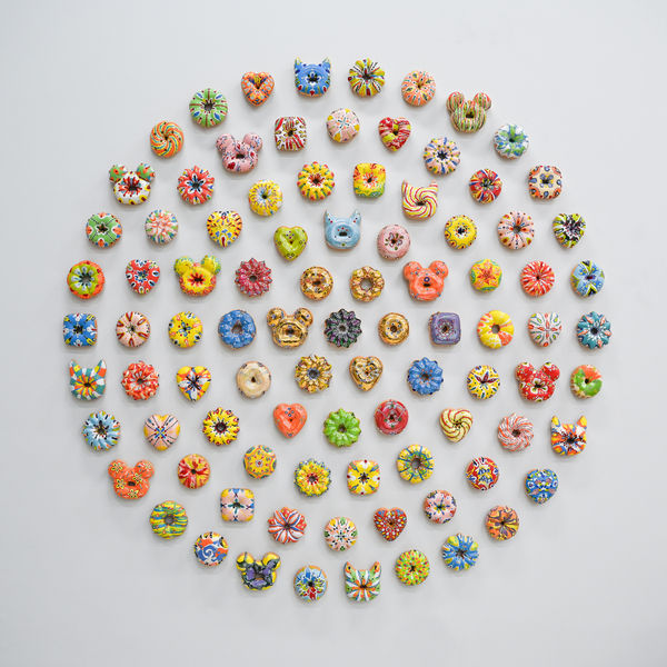 Individually made ceramic glazed donut wall sculptures with unique colors and shapes